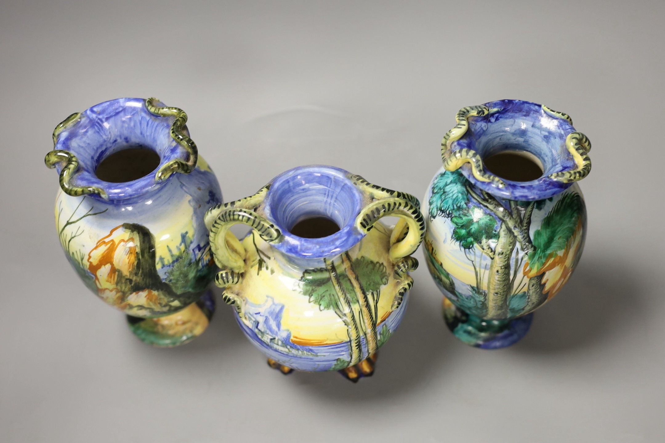 A pair of Italian maiolica vases, by Cantagalli and a similar two handled vase, cockerel marks, pair 17 cms high